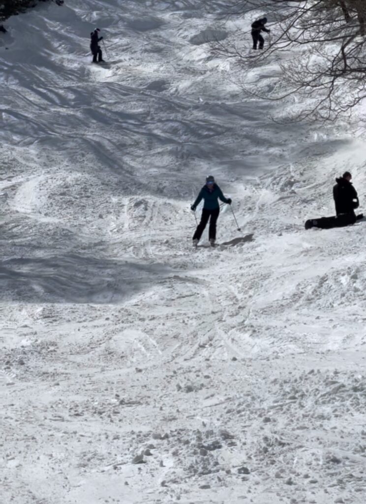 woman skiing a mogul field